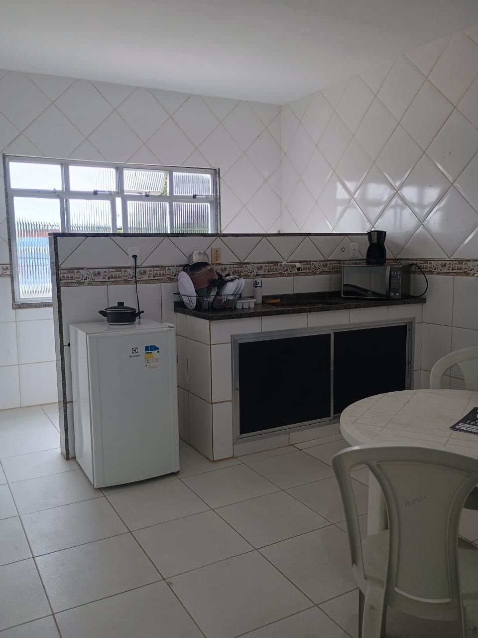 Mini-fridge, microwave, cookware/dishes/utensils, dining table