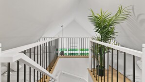 A white staircase with black railings leading to a balcony with a view of a green landscape. - Spa | Mountain | Modern Comfort | Elska (Saint-Côme)