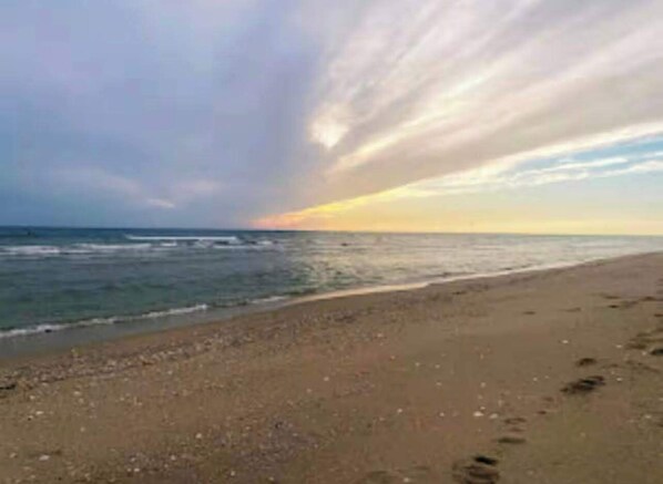 A beach with a wide sandy shore and the ocean.