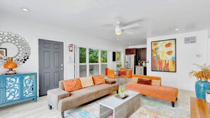 A modern living room with a sofa, coffee table, and decorative items. - Orange Dream on the Water (Fort Lauderdale)