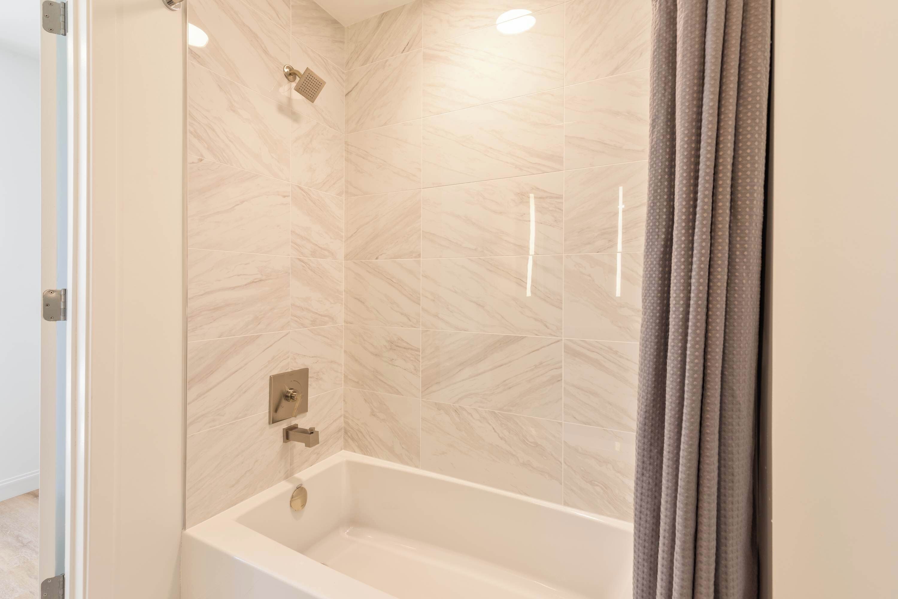 A bathroom with a bathtub, a shower, and a toilet.