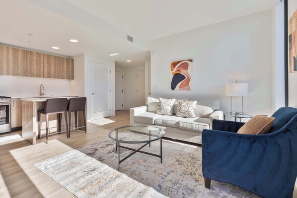 Relax in a stylish living space with a sofa, coffee table, and dining area.