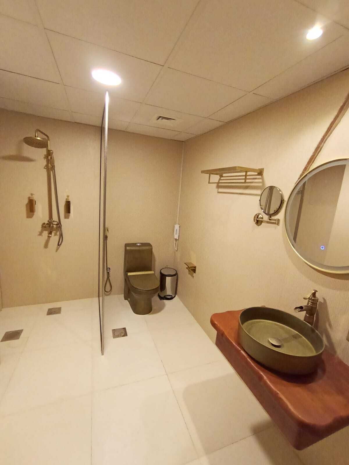 A bathroom with a shower, toilet, and sink.