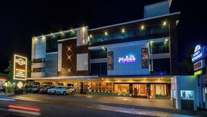 A modern hotel with a prominent 'Malika Residency' sign, a bar, and a restaurant. - Hotel Malika Residency (Ettumanoor)