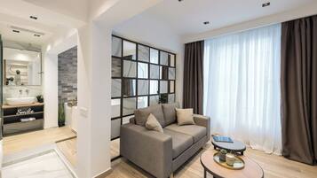 Suite with hot tub | Living area | Flat-screen TV