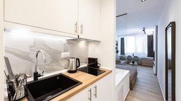 Mini-fridge, stovetop, cookware/dishes/utensils