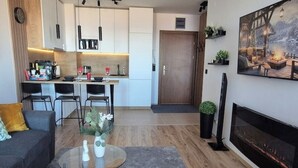 Un salon moderne avec un canapé, une table basse et une cheminée.