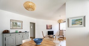 Enjoy meals at the dining table surrounded by comfortable chairs and a stylish light fixture.