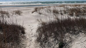 A beach with sand dunes and a clear blue sky. - Ocean Views & Surf Fishing Paradise at The Point – Perfect Family Escape! (Emerald Isle)