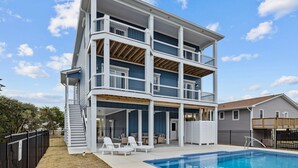 A multi-story building with a pool, outdoor seating, and a covered patio area. - Ocean Views & Surf Fishing Paradise at The Point – Perfect Family Escape! (Emerald Isle)
