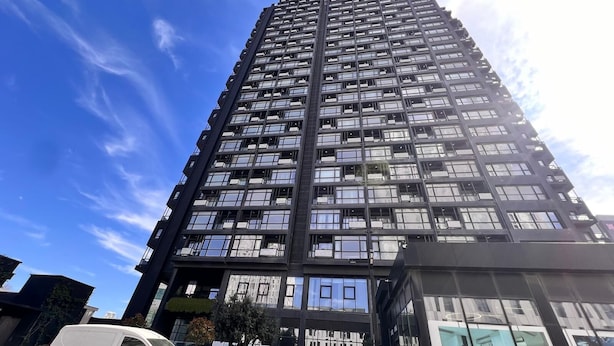 A high-rise building with multiple floors, large windows, and a modern architectural design. - G Tower Residence Apartment Rentals (Istanbul)