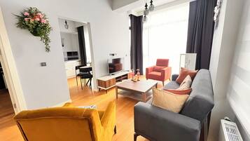 Deluxe Condo, 1 Bedroom, City View | Living area | 80-cm LED TV with cable channels