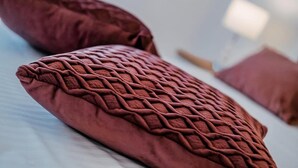 A close-up of a textured, woven fabric pillow on a bed. - New! Studio partment A1 in Okrug Donji (Okrug Donji)