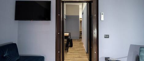 Deluxe Triple Room, Balcony | In-room safe, desk, laptop workspace, blackout drapes