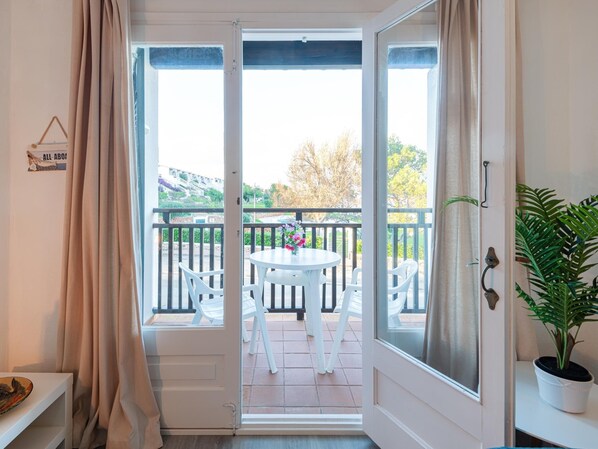 Enjoy the view from your balcony with a table and chairs, perfect for taking in the surroundings.