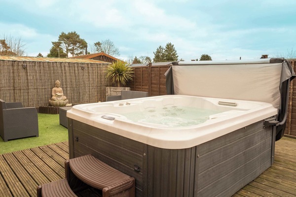 Relax in your own exclusive spa garden — bubbling hot tub, ambient seating, and peaceful zen-inspired surroundings await.