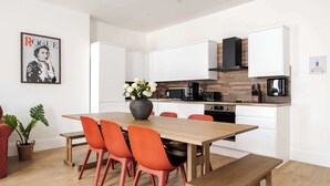 A modern kitchen with white cabinets, a wooden countertop, and a black coffee maker. - Stunning 2BR 2BA in the ♥️ of Marylebone ❄️ Air Conditioning | Sleeps 8 (Greater London)