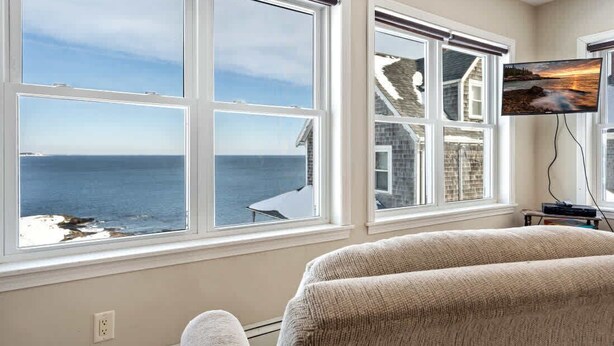 A room with large windows overlooking the sea, a television on the wall, and a sofa. - Oceanfront Views, 2 Living Rooms, Walk to Beach (York)