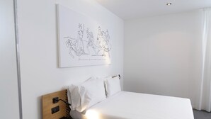 A neatly made bed with white linens, a wooden headboard, and a wall-mounted artwork depicting a group of people. - Standard Triple Studio with Fimestra (Bagheria)