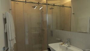 A modern bathroom with a glass-enclosed shower, a white sink, and a toilet. - Superior Double Apartment with Balcony (Bagheria)