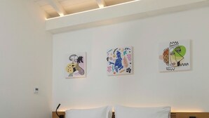 A modern bedroom with a large bed, white bedding, and three wall-mounted artworks. - Superior Double Apartment with Balcony (Bagheria)