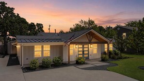 A single-story house with a front porch, a garage, and a well-maintained lawn.