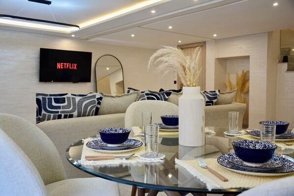 Relax in this inviting space with a comfortable sofa, flat-screen TV, and dining area.