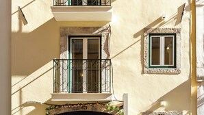 A multi-story building with balconies, windows, and a door. - Saudade Center Alfama II (Lisbon)