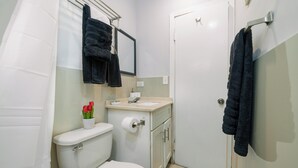 A small bathroom with a toilet, sink, and towel rack. - Stylish 1-bedroom apartment in delightful Buckleys with WiFi, AC (Buckleys)