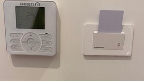 A thermostat, a card slot, and a light switch on a wall. - Superior Double Room with AC (Roma)