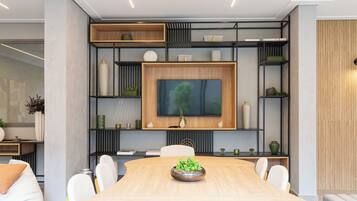 A modern dining area with a wooden table, white chairs, and a central decorative bowl.