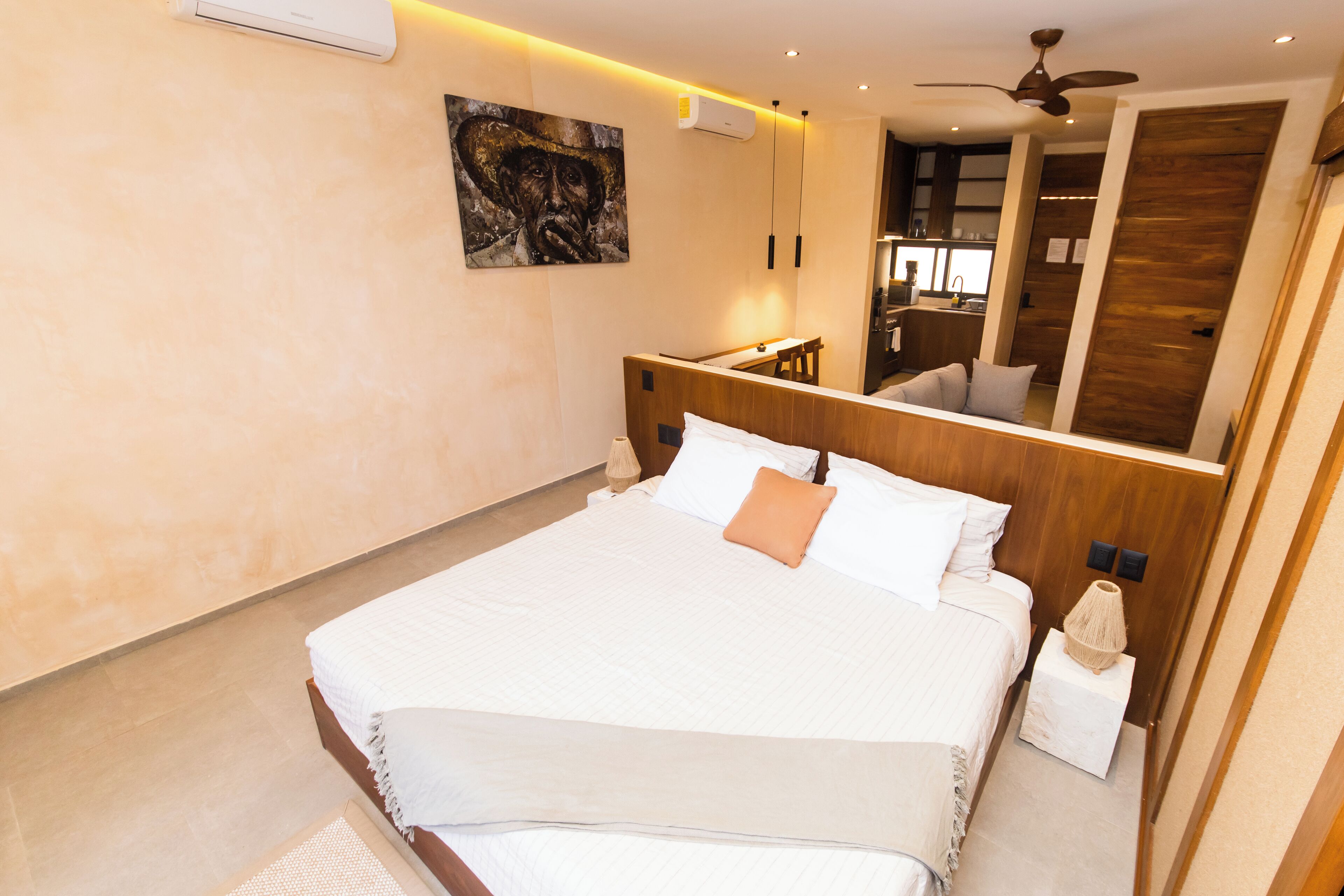 Una camera da letto moderna con un letto grande, una ventola a soffitto e uno specchio.