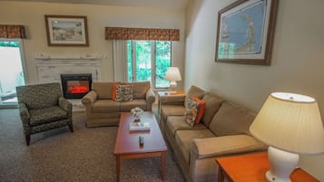 Deluxe Suite, 2 Bedrooms | Living area | 32-inch flat-screen TV with satellite channels, fireplace, DVD player