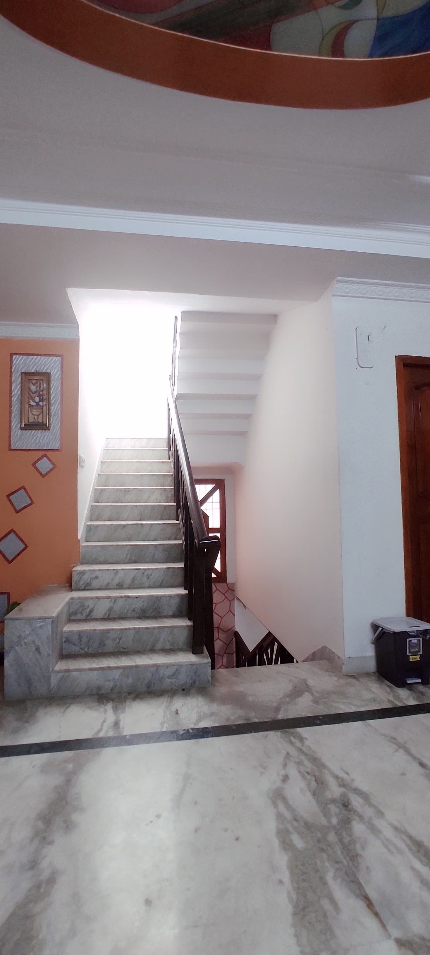A staircase with marble steps leading to a landing.