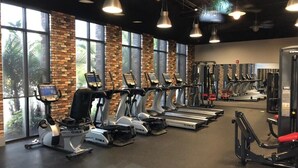A gym with treadmills, elliptical machines, and weight equipment.