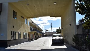 A parking garage with a car under an overhang. - Corcoran Inn (Corcoran)