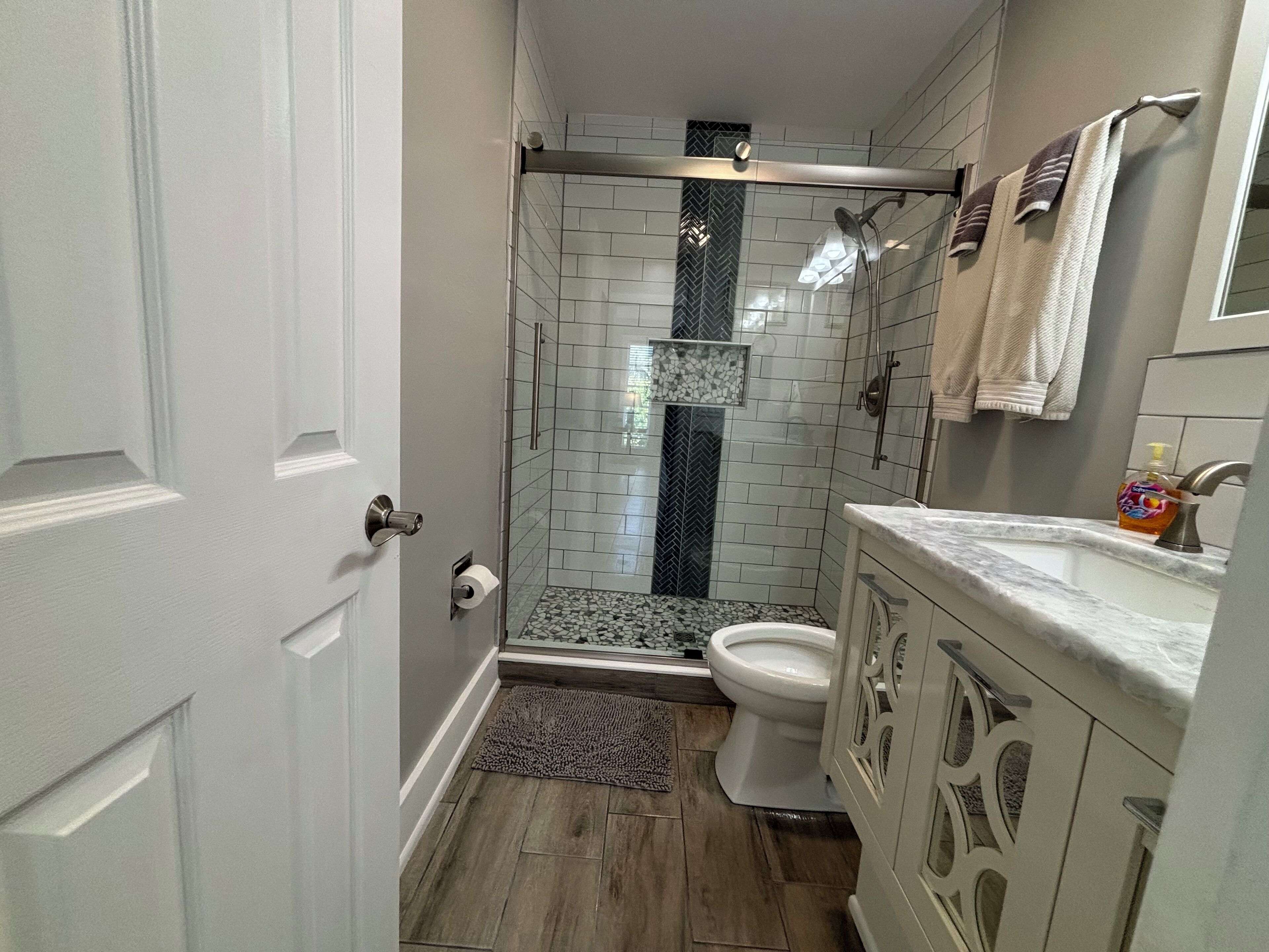 Shower, hair dryer, towels, toilet paper