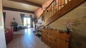 A spacious living area with a wooden staircase, tiled flooring, and a dining area with a table and chairs. - HOUSE WITH A VIEW OF THE PYRENEES OF THE ARIEGE AT TREZIERS NEAR MIREPOIX (Tréziers)