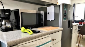 A kitchen with a microwave, coffee maker, and a refrigerator. - Playa del Carmen Apartment (Playa del Carmen)