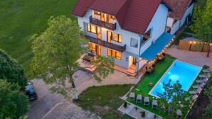 A multi-story house with a swimming pool, outdoor seating, and a well-maintained lawn. - Apartments Villa Mavi - Two Bedroom Apartment First Floor (Karlovac)
