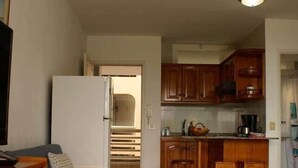 A compact living space with a kitchenette, a sofa, and a dining area. - Mar de Lava (Puerto de Naos)