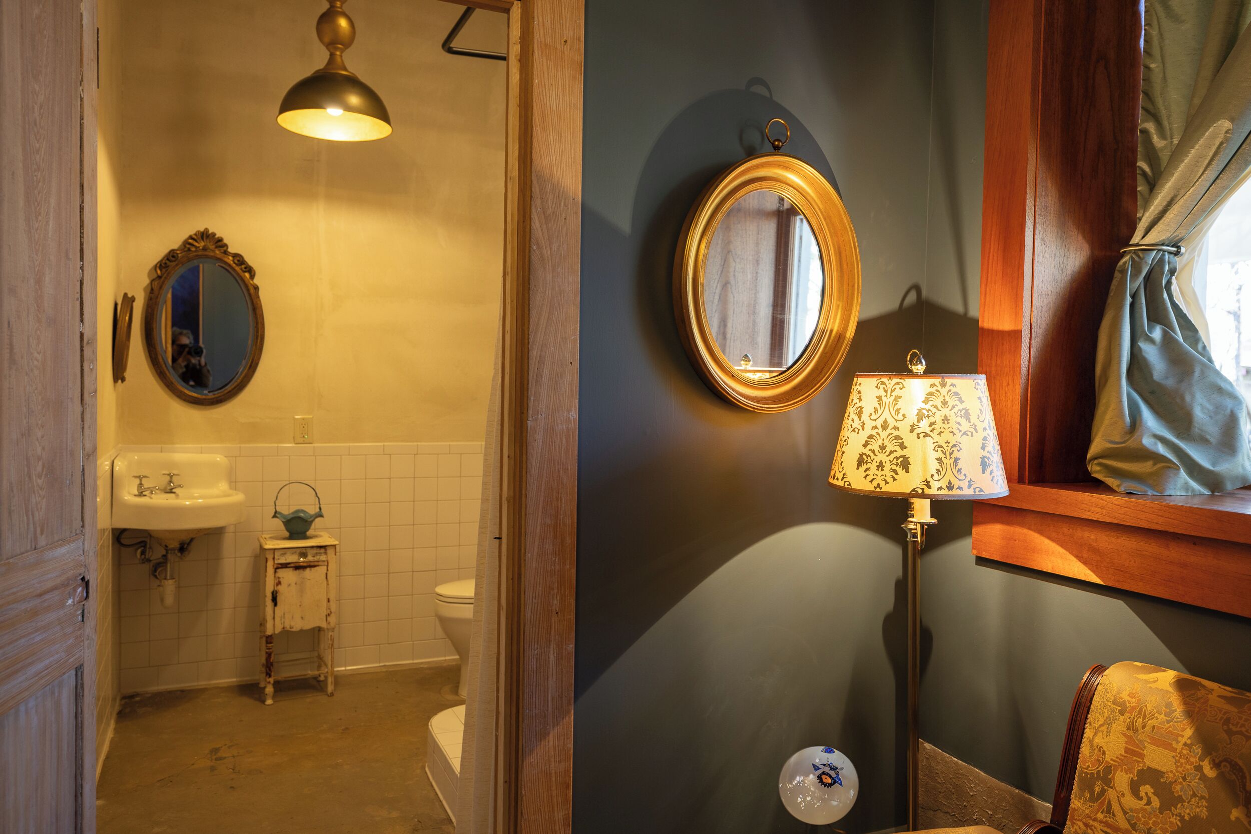 A bathroom with a sink, toilet, and a mirror.