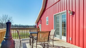 A red building with a deck, a table, and chairs. - 'Red Barn Getaway' Chillicothe Countryside Home (Chillicothe)