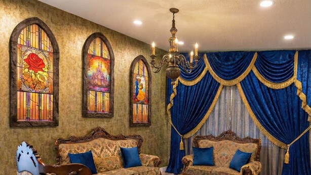A room with ornate furniture, stained glass windows, and a chandelier.