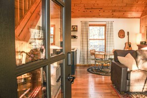 Relax in this inviting space with a leather sofa, wooden rocking chair, and dining table.