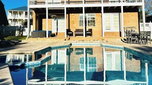 A two-story building with a swimming pool in front. - Granny's at the Beach…Heated Pool (Panama City Beach)