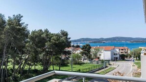 A coastal residential area with houses, a road, and a view of the sea and hills in the distance. - 1 bedroom awesome apartment in Biograd na Moru (Biograd na Moru)
