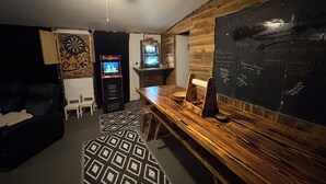 Ein Zimmer mit einer Holzwand und zahlreichen Dartscheiben.