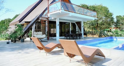 Step into an A-Frame home, where white tropical design meets ultimate comfort.