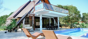 Step into an A-Frame home, where white tropical design meets ultimate comfort.